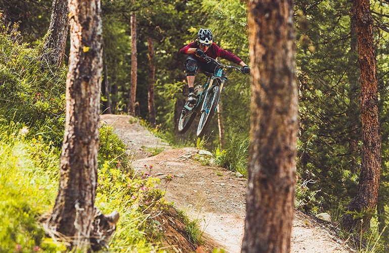 Mountain biker in the forests of Carosello 3000